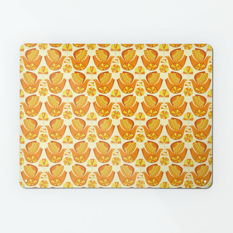 A large magnetic notice board by Beyond the Fridge with a retro style repeat pattern design of citrus birds in orange and lemon colours
