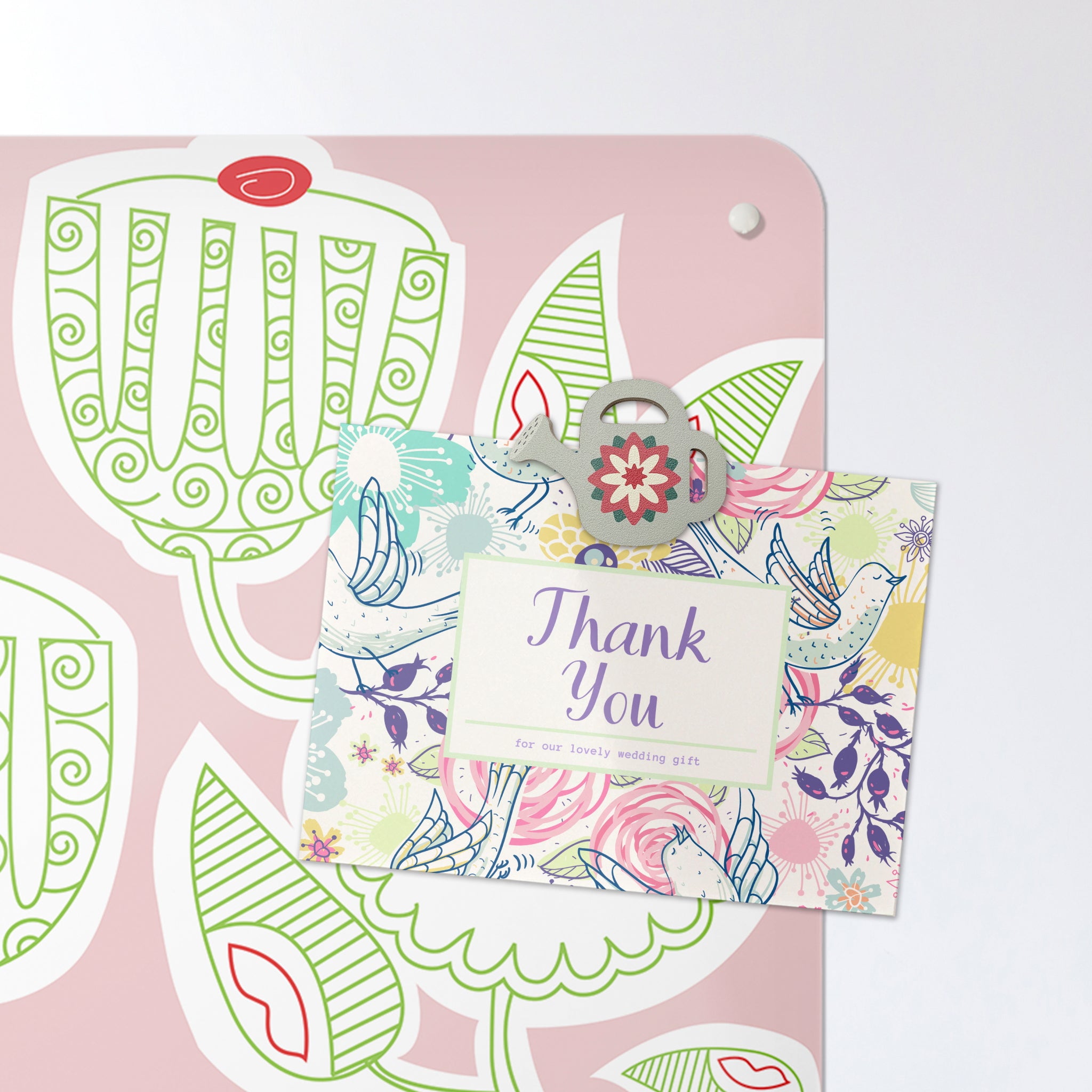 A postcard on a pink cupcake plant design magnetic board or metal wall art panel with a plywood watering can design fridge magnet