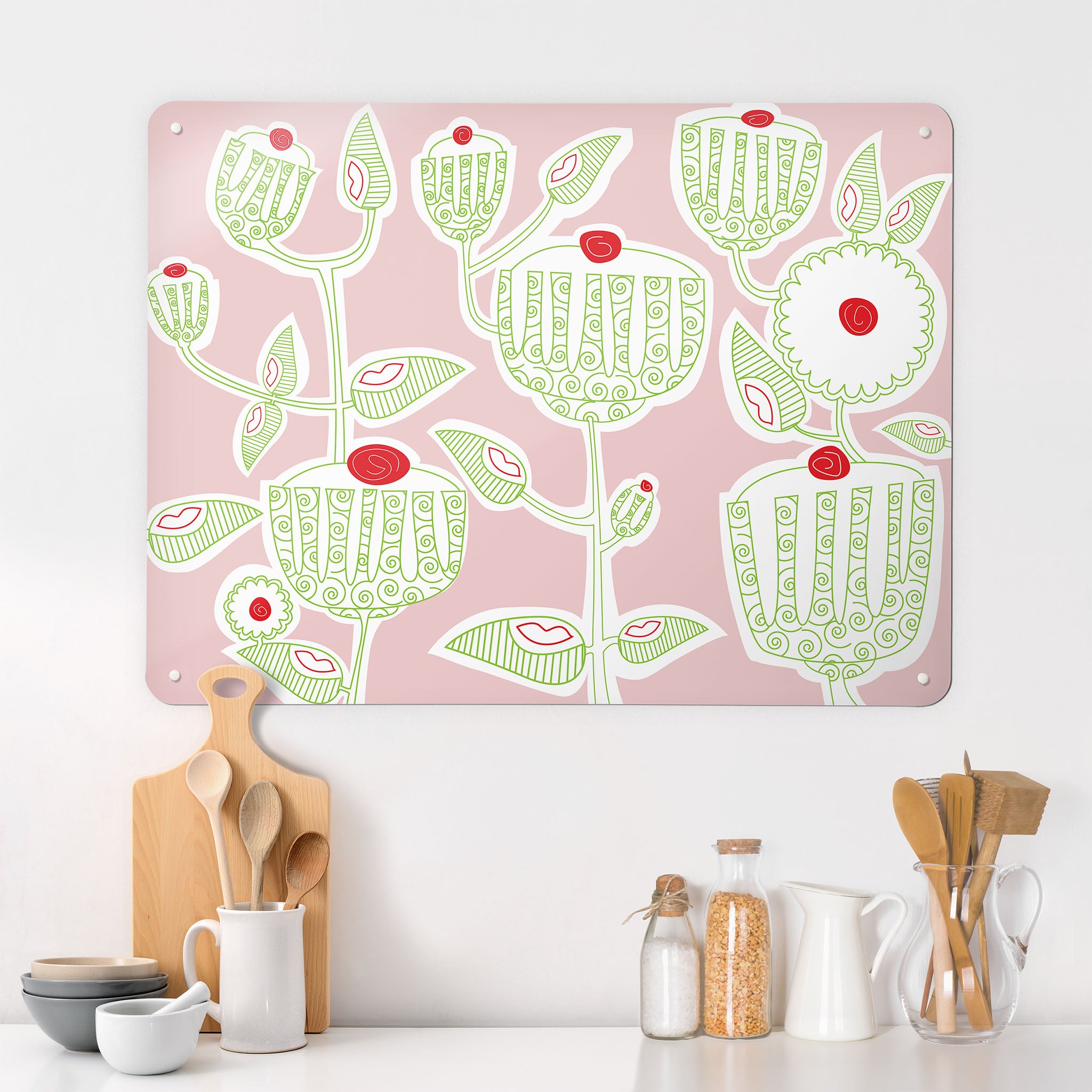 A kitchen interior with a magnetic metal wall art panel showing a cupcake plant design in green, red, white and pink