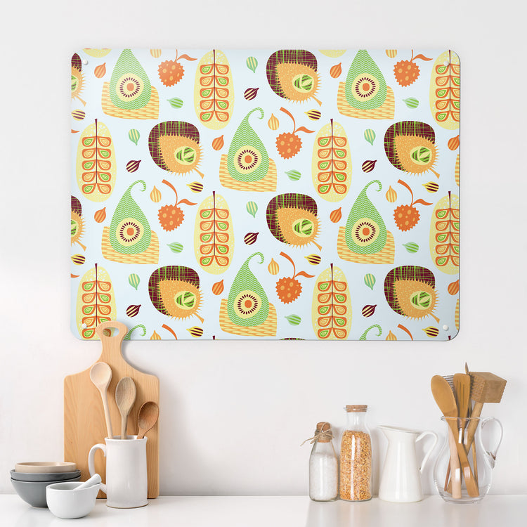 A kitchen interior with a magnetic metal wall art panel showing a repeat pattern design of exotic fruit
