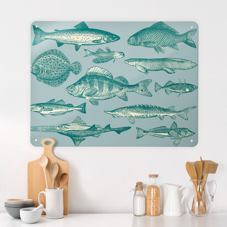 A kitchen  interior with a magnetic metal wall art panel showing a shoal of fish illustration in blue