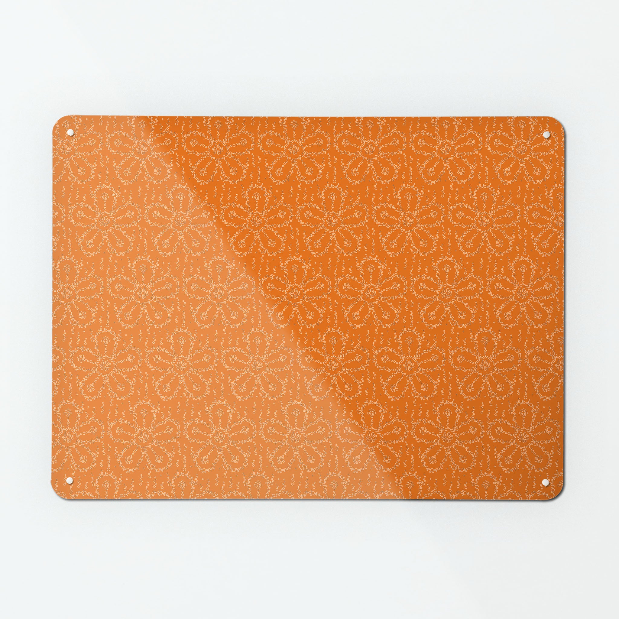 A large magnetic notice board by Beyond the Fridge with a fizzy flower pattern in orangeade colour