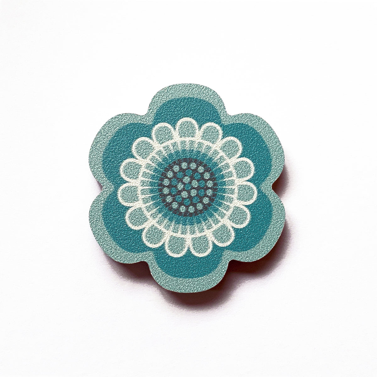 An aqua flower shaped plywood fridge magnet by Beyond the Fridge