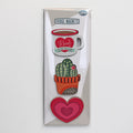 The gift set of three fridge magnets for mums, in its packaging: a Mum mug, a cactus and a heart