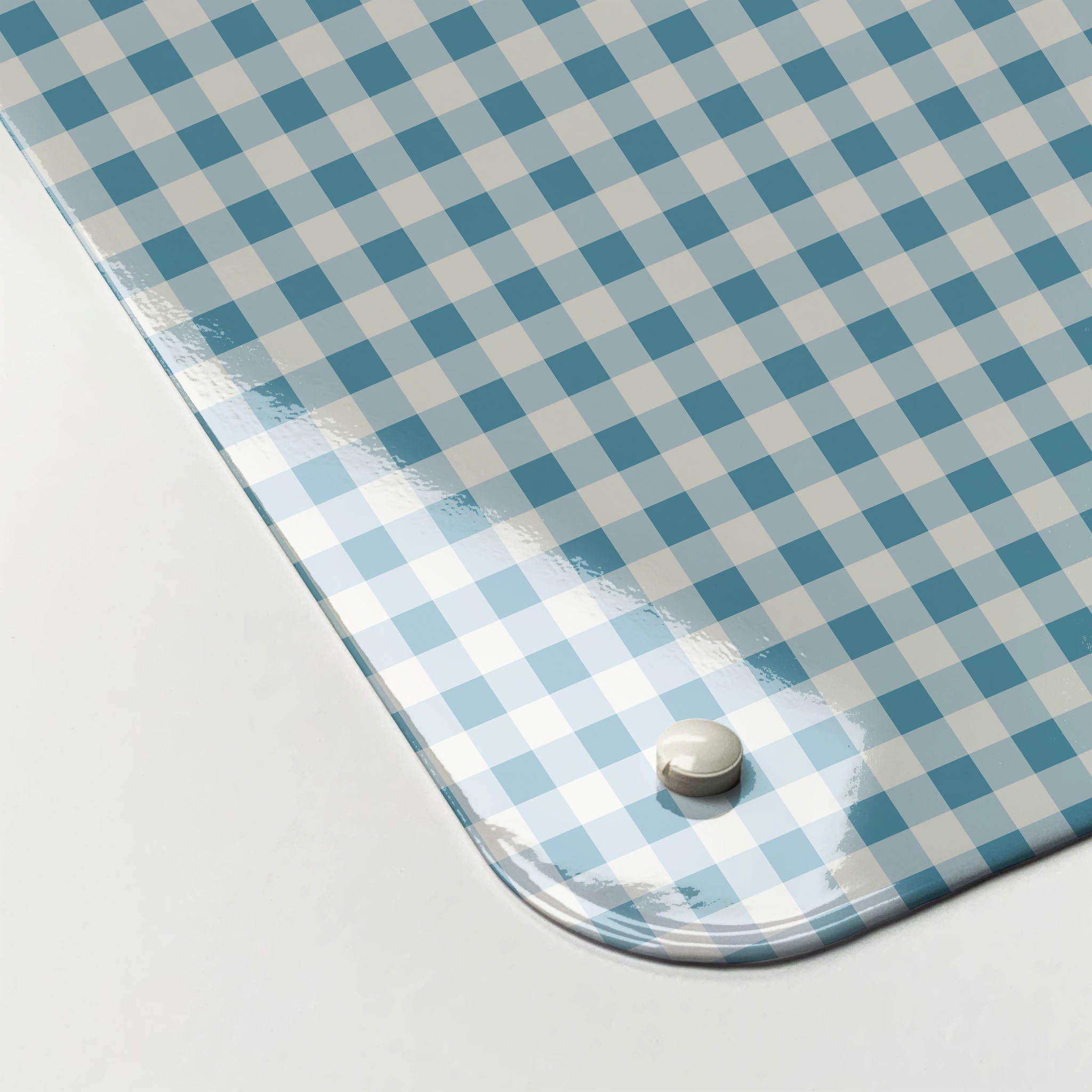 The corner detail of a blue gingham design magnetic board to show it’s high gloss surface