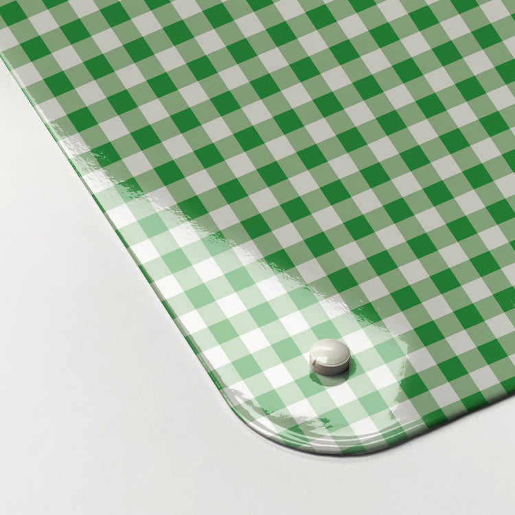 The corner detail of a green gingham design magnetic board to show it’s high gloss surface