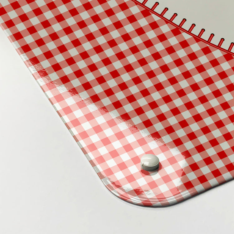 The corner detail of a gingham heart design dry wipe magnetic board to show it’s high gloss surface