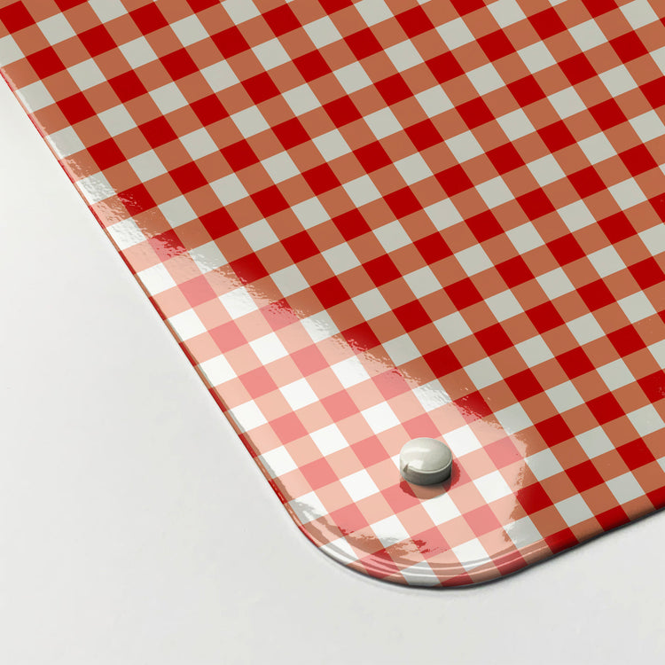 The corner detail of a red gingham design magnetic board to show it’s high gloss surface