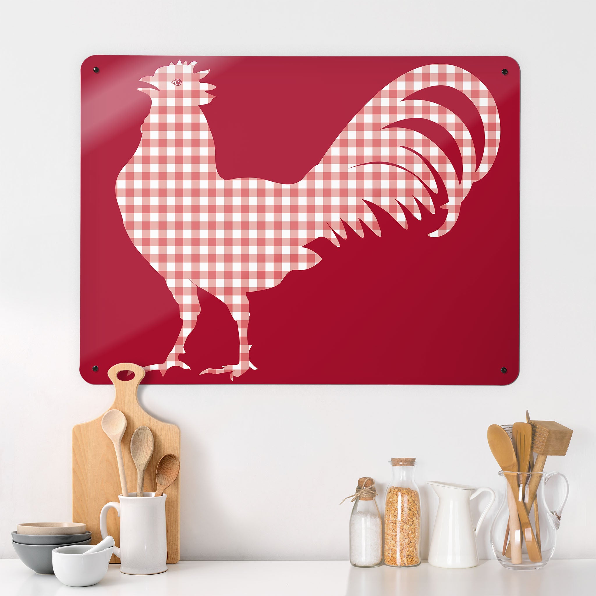 A kitchen interior with a magnetic metal wall art panel with a red gingham cockerel design