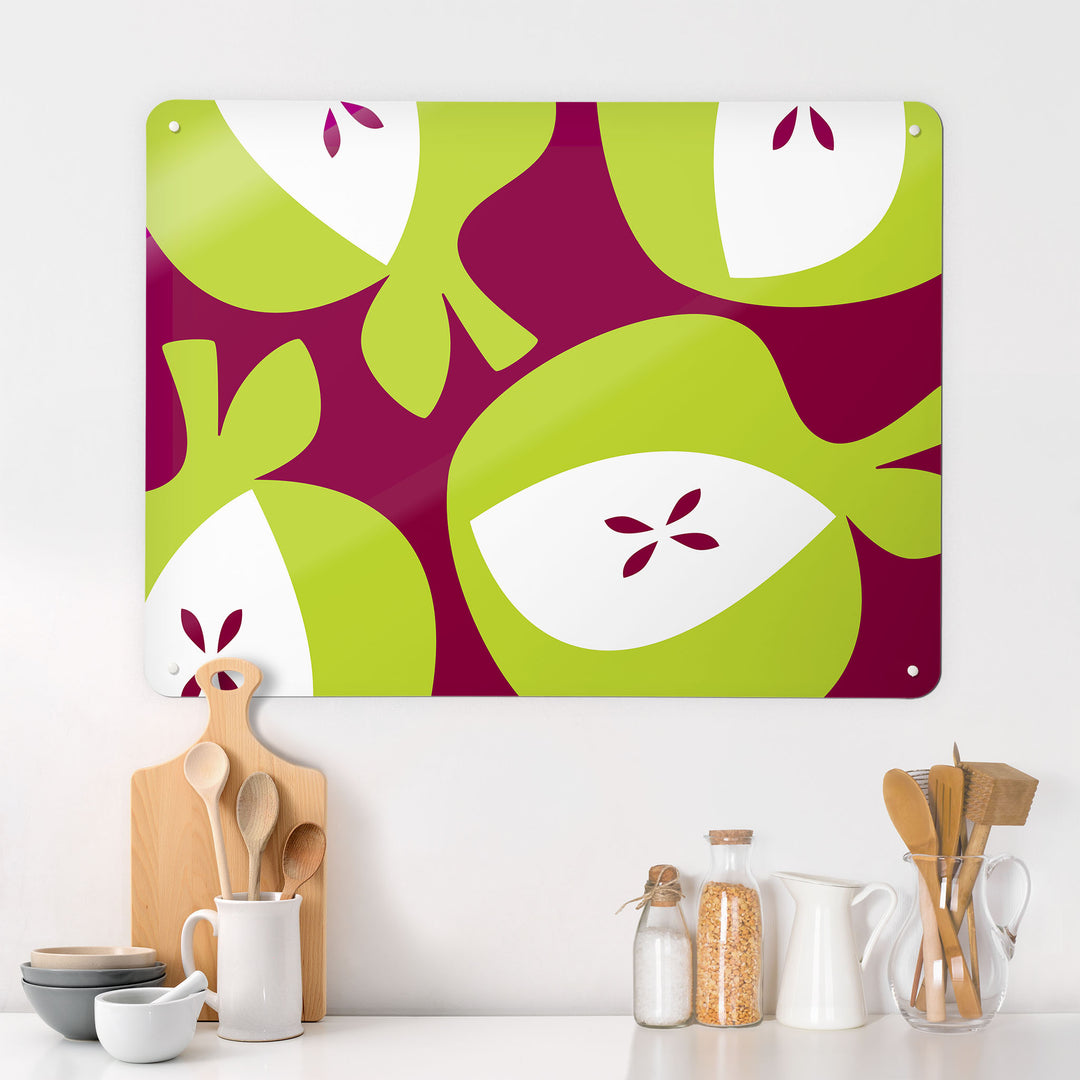 A kitchen interior with a magnetic metal wall art panel showing an apples design in green and burgundy