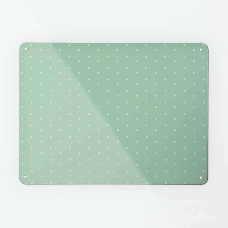 A large magnetic notice board by Beyond the Fridge with a pale green polkadots on a green background pattern