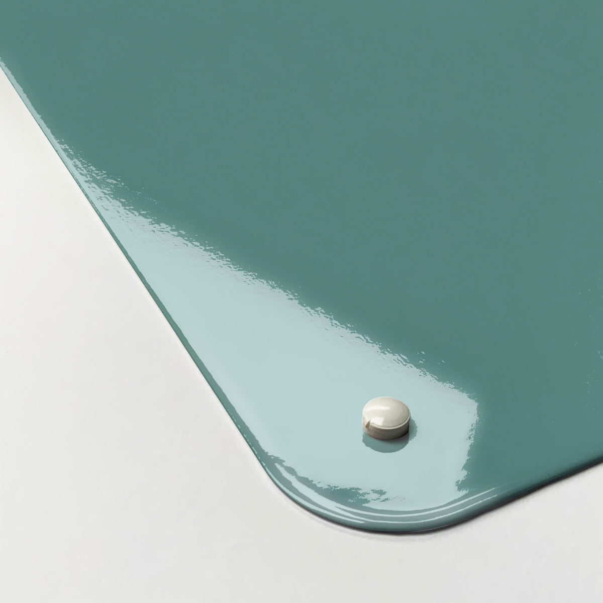 The corner detail of a blue vintage keep calm and carry on magnetic board to show it’s high gloss surface