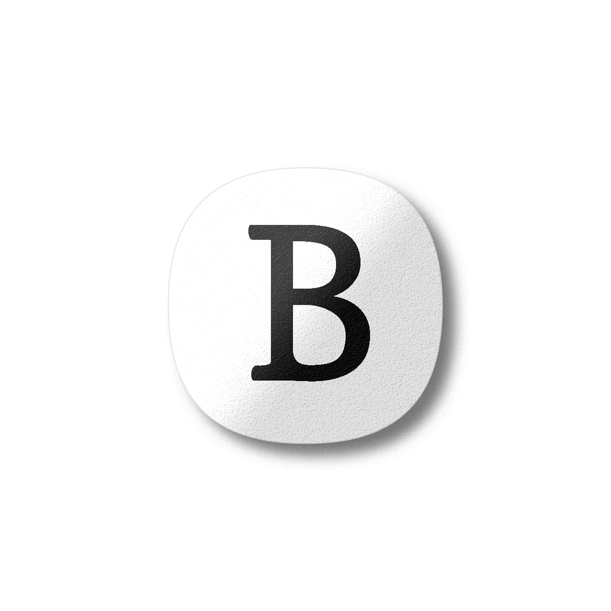 A white magnet with a black letter B plywood fridge magnet by Beyond the Fridge