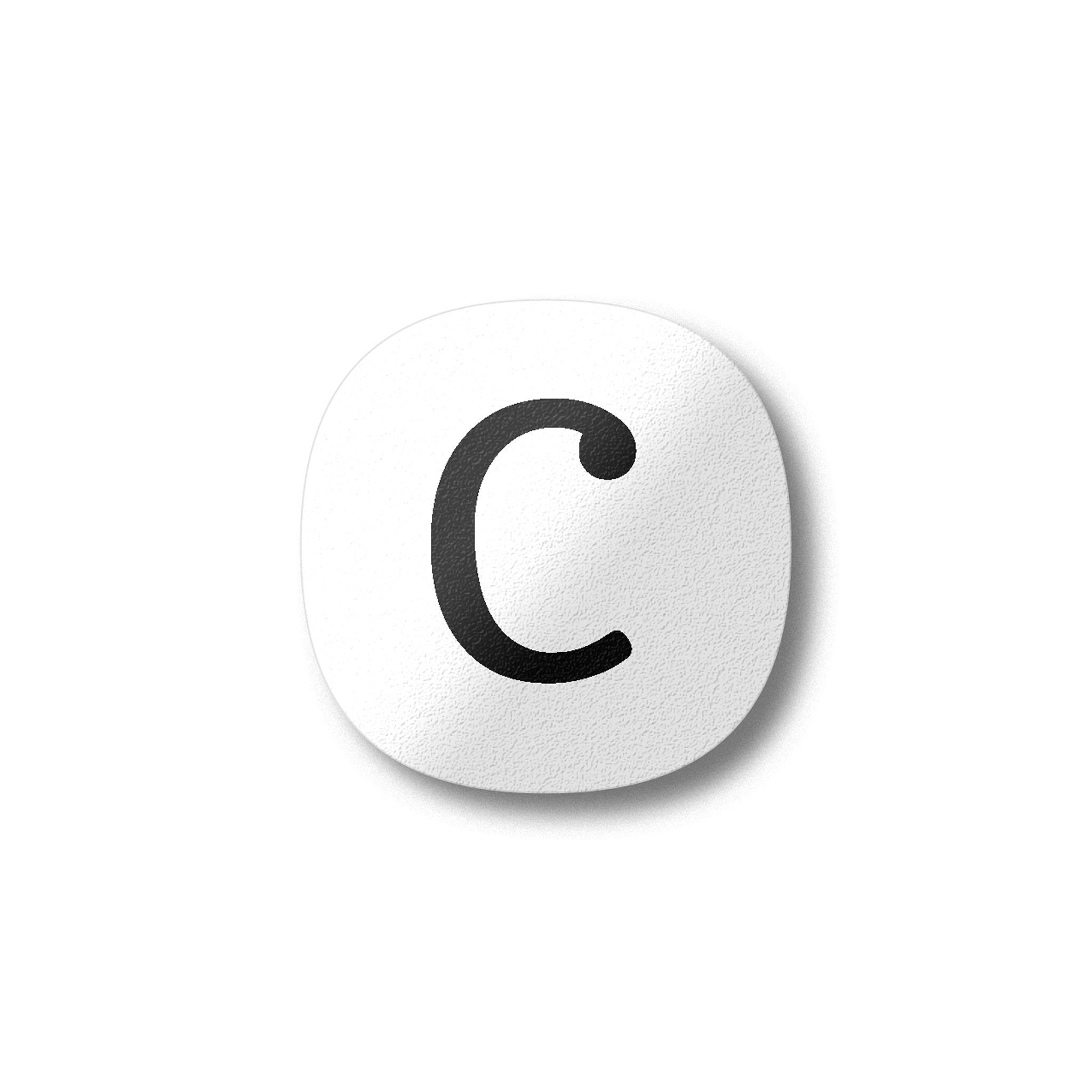 A white magnet with a black letter C plywood fridge magnet by Beyond the Fridge