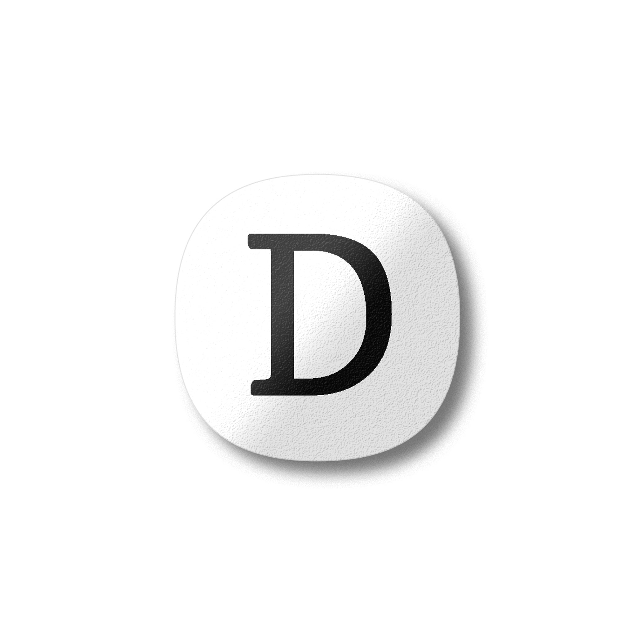 A white magnet with a black letter D plywood fridge magnet by Beyond the Fridge
