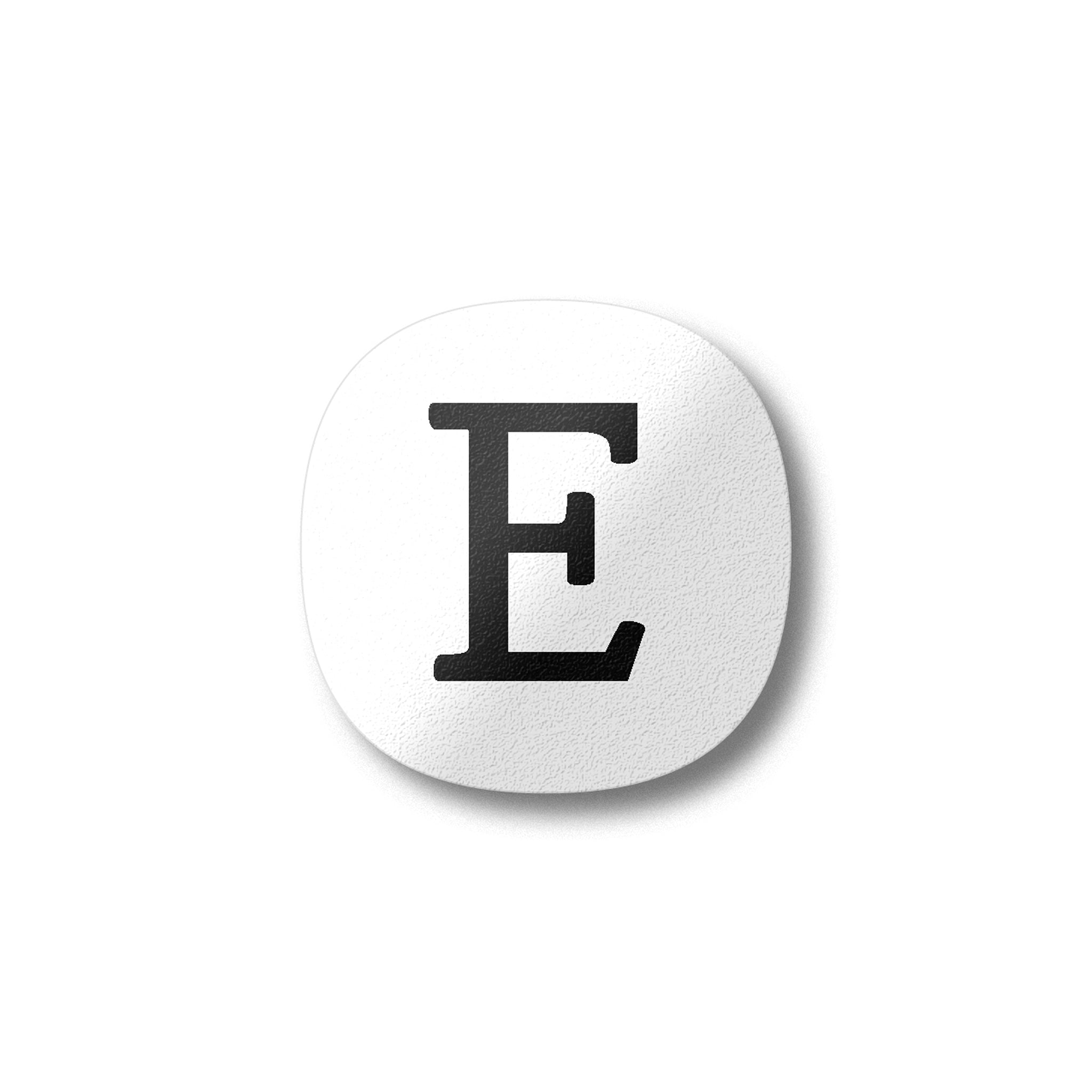A white magnet with a black letter E plywood fridge magnet by Beyond the Fridge
