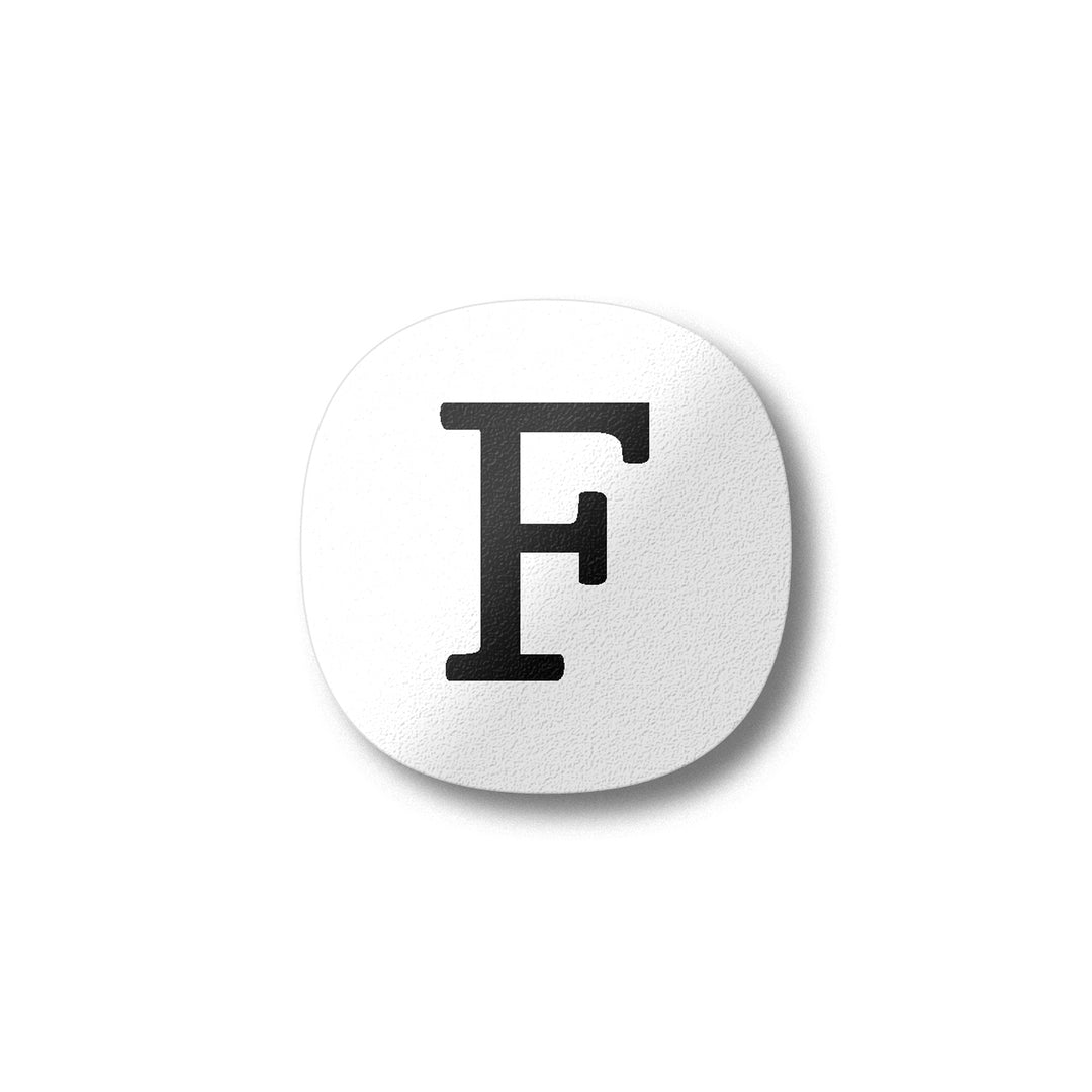 A white magnet with a black letter F plywood fridge magnet by Beyond the Fridge