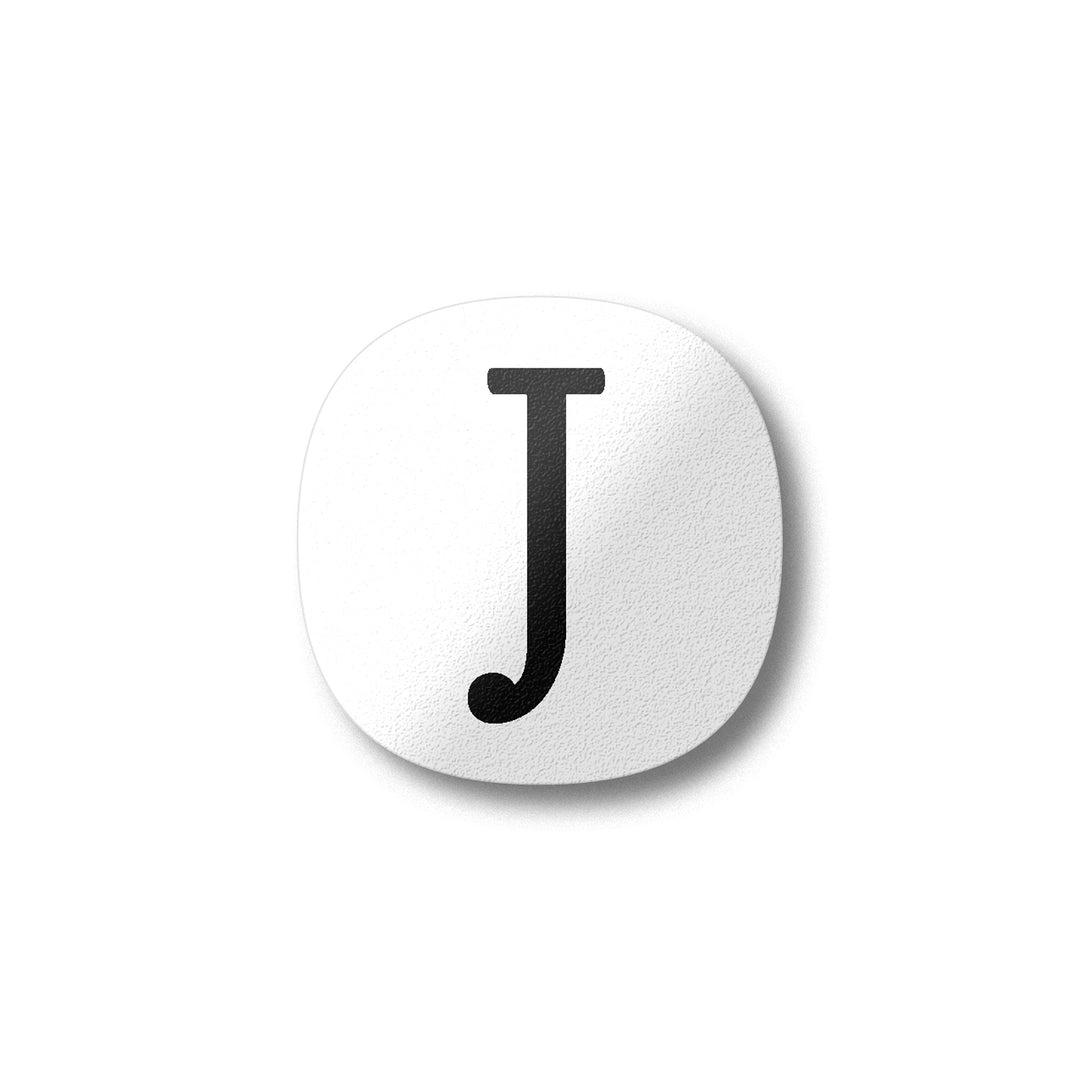 A white magnet with a black letter J plywood fridge magnet by Beyond the Fridge