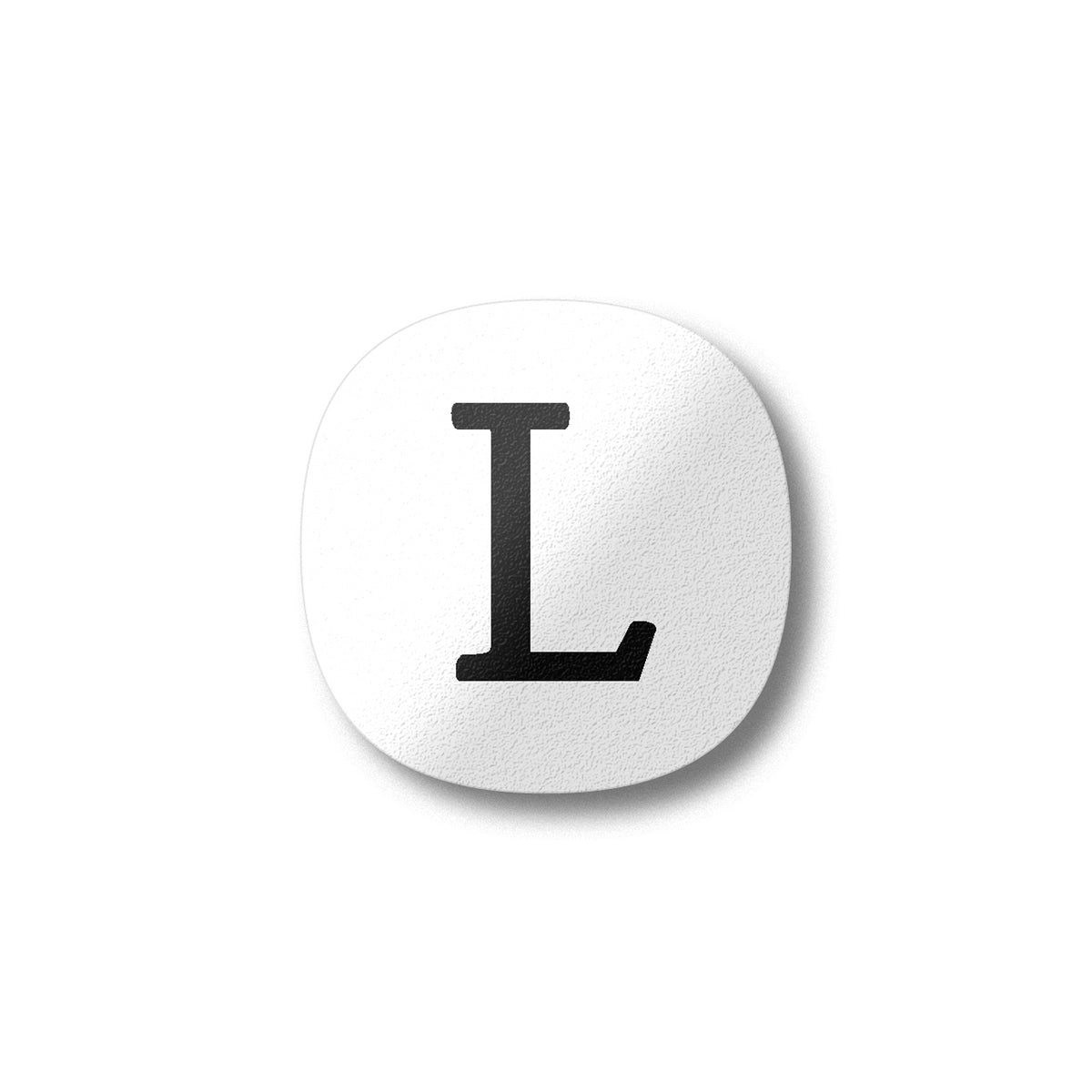 A white magnet with a black letter L plywood fridge magnet by Beyond the Fridge