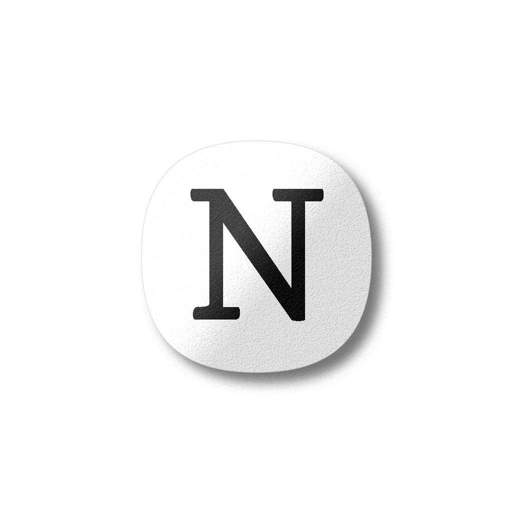 A white magnet with a black letter N plywood fridge magnet by Beyond the Fridge