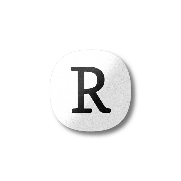 A white magnet with a black letter R plywood fridge magnet by Beyond the Fridge