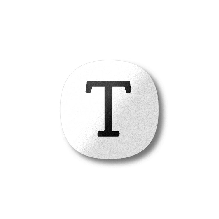 A white magnet with a black letter T plywood fridge magnet by Beyond the Fridge