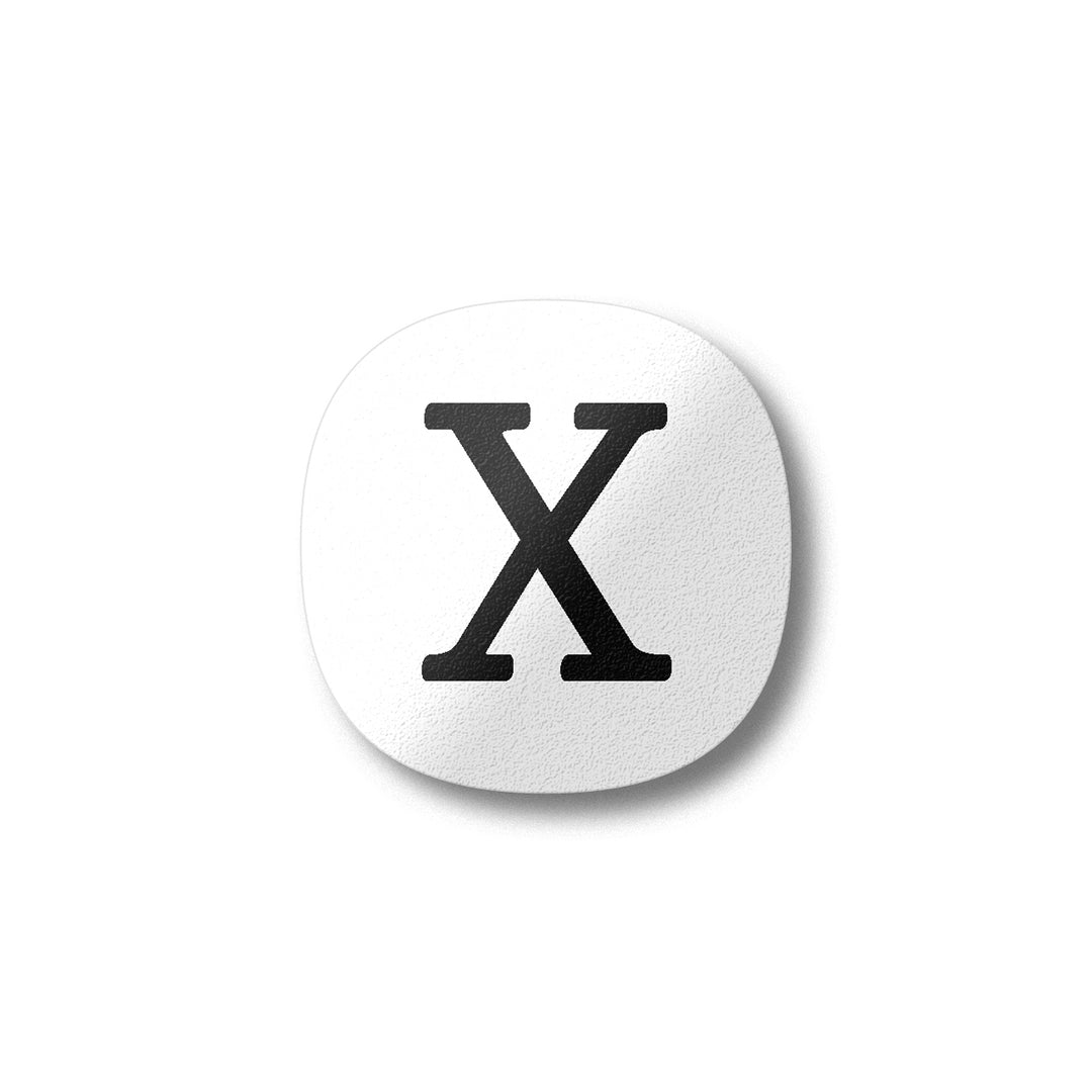 A white magnet with a black letter X plywood fridge magnet by Beyond the Fridge
