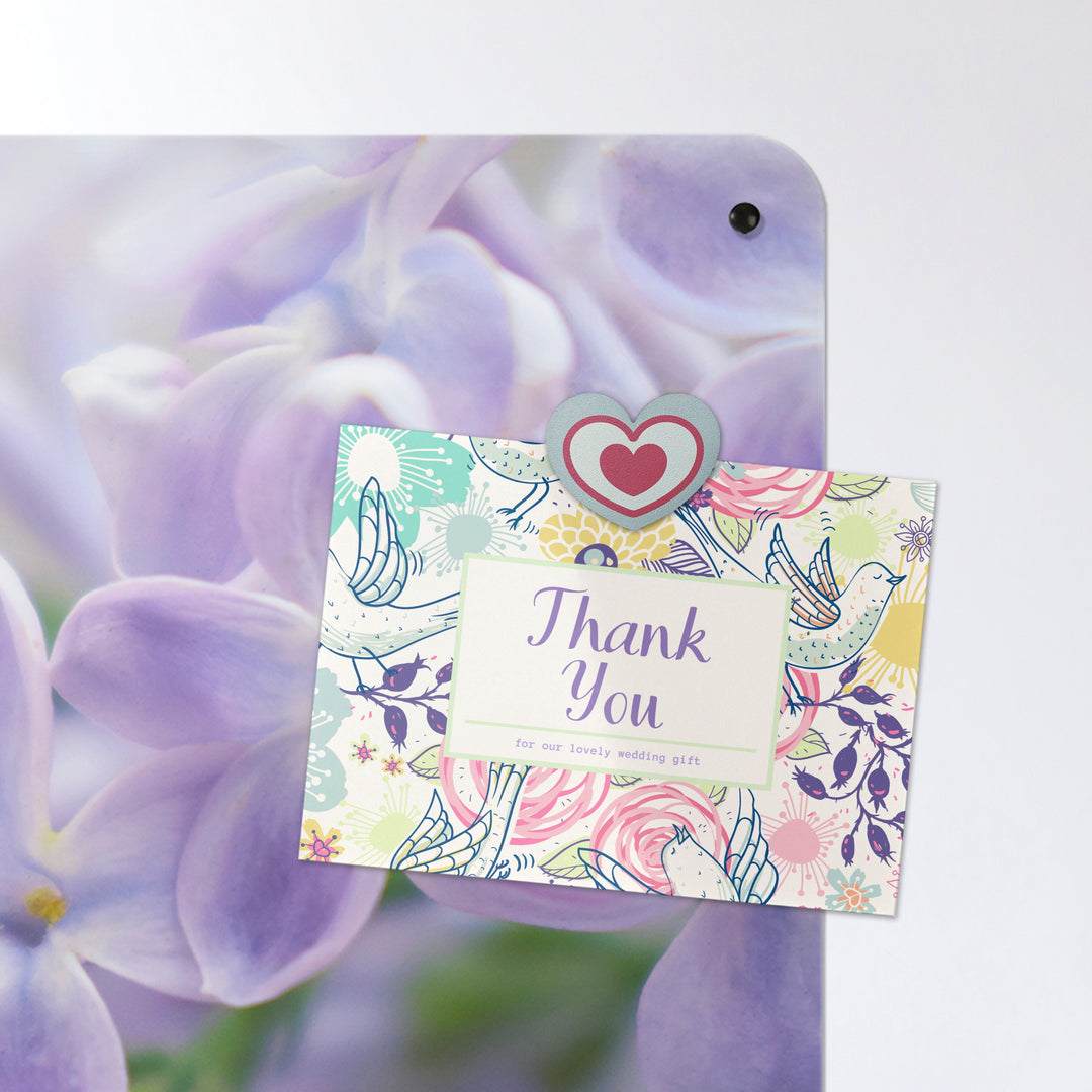 A postcard on a lilac flowers photographic magnetic board or metal wall art panel