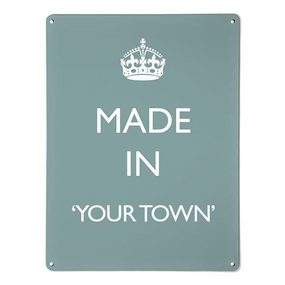 A large magnetic notice board by Beyond the Fridge with a made in your town typographic design to personalise in white lettering on blue