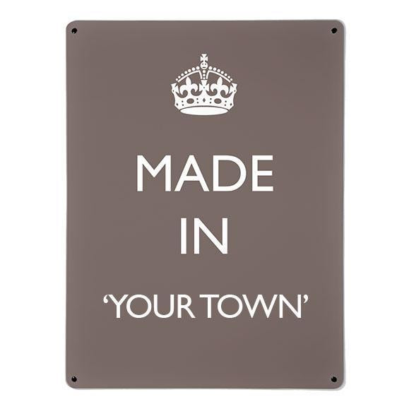 A large magnetic notice board by Beyond the Fridge with a made in your town typographic design to personalise in white lettering on brown