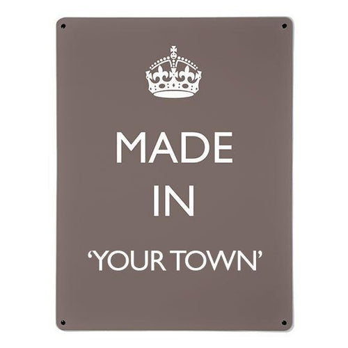 A large magnetic notice board by Beyond the Fridge with a made in your town typographic design to personalise in white lettering on brown