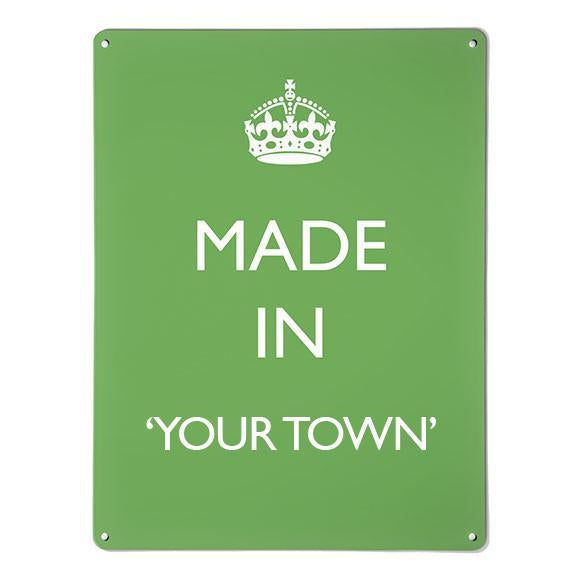 A large magnetic notice board by Beyond the Fridge with a made in your town typographic design to personalise in white lettering on green