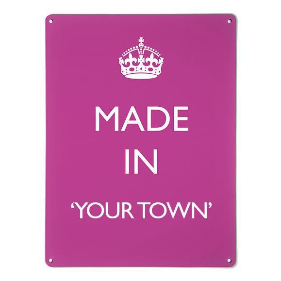 A large magnetic notice board by Beyond the Fridge with a made in your town typographic design to personalise in white lettering on pink