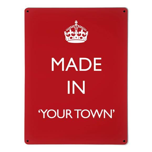 A large magnetic notice board by Beyond the Fridge with a made in your town typographic design to personalise in white lettering on red
