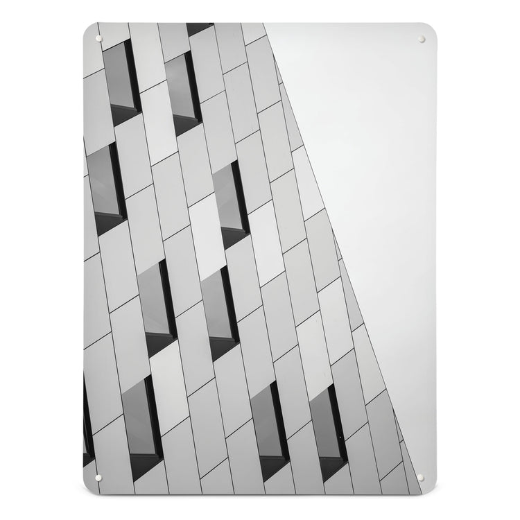 A large magnetic notice board by Beyond the Fridge with an image of an abstract building and windows in black and white 
