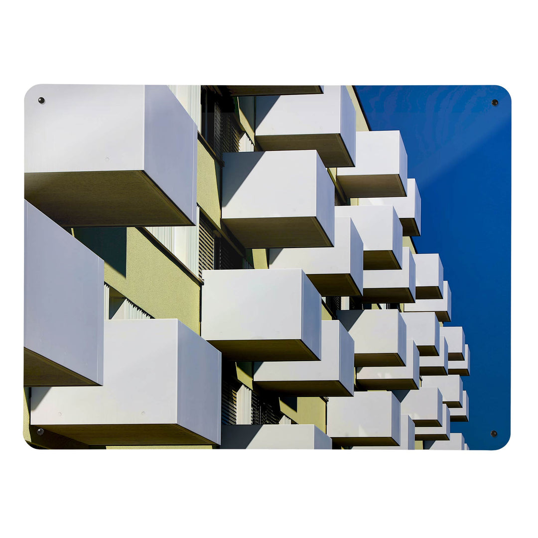 A large magnetic notice board by Beyond the Fridge with an image of brutalist balconies and a blue sky