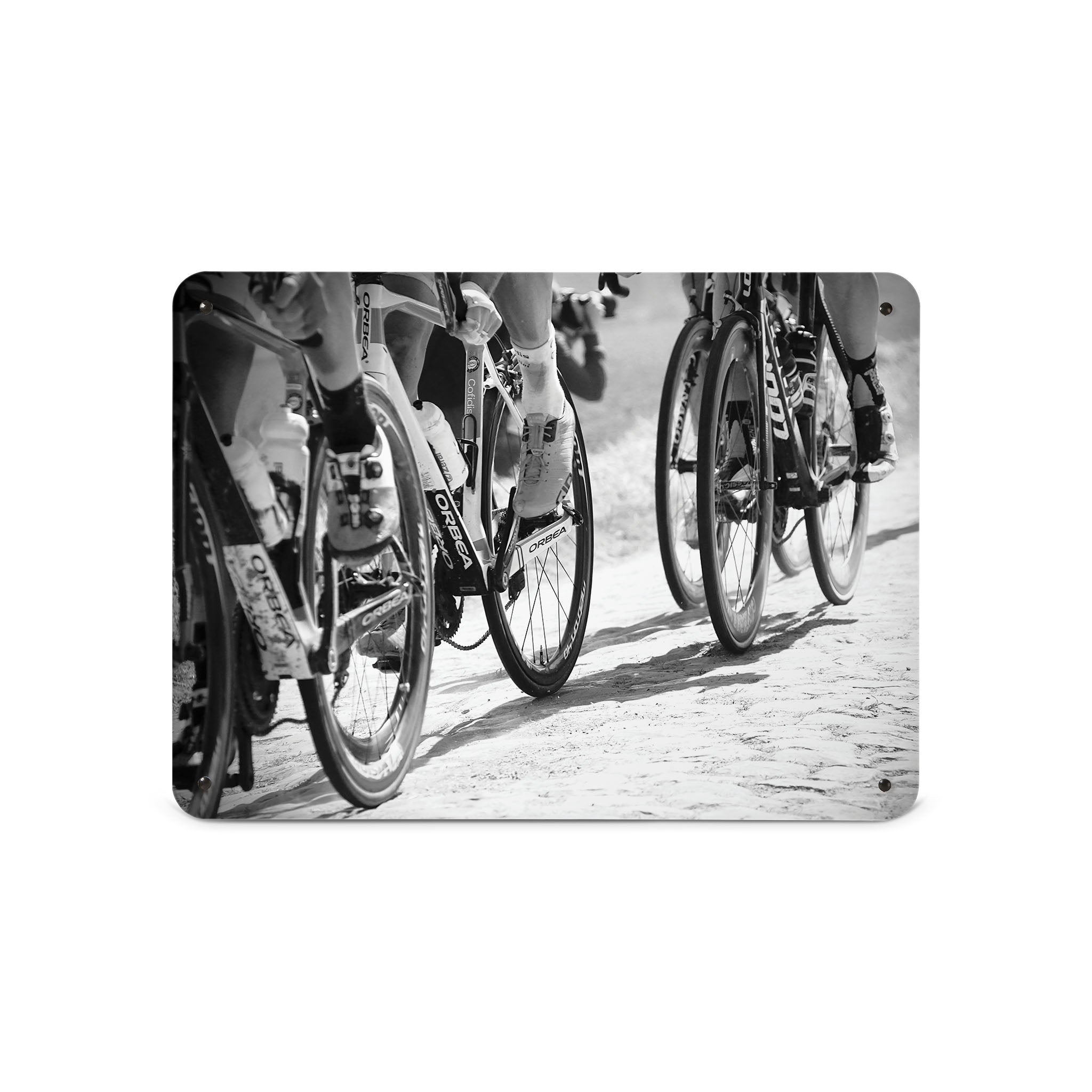 A medium magnetic notice board by Beyond the Fridge with a black and white image of cyclists focusing on the wheels of the bikes