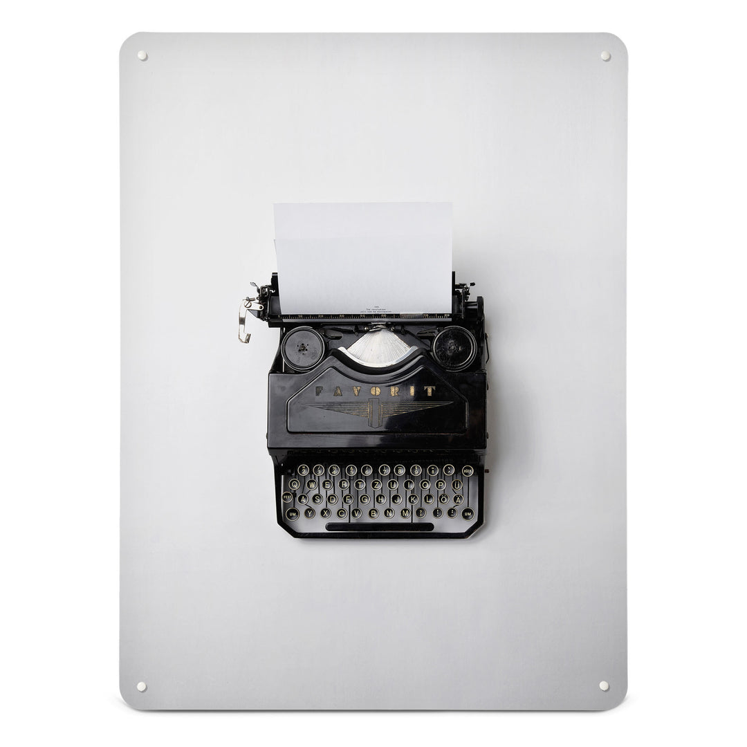 A large magnetic notice board by Beyond the Fridge with a photograph of a vintage typewriter on a white background