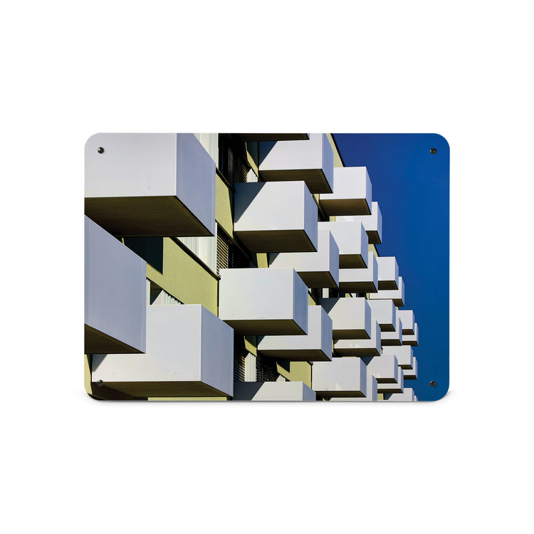 A medium magnetic notice board by Beyond the Fridge with an image of brutalist balconies and a blue sky