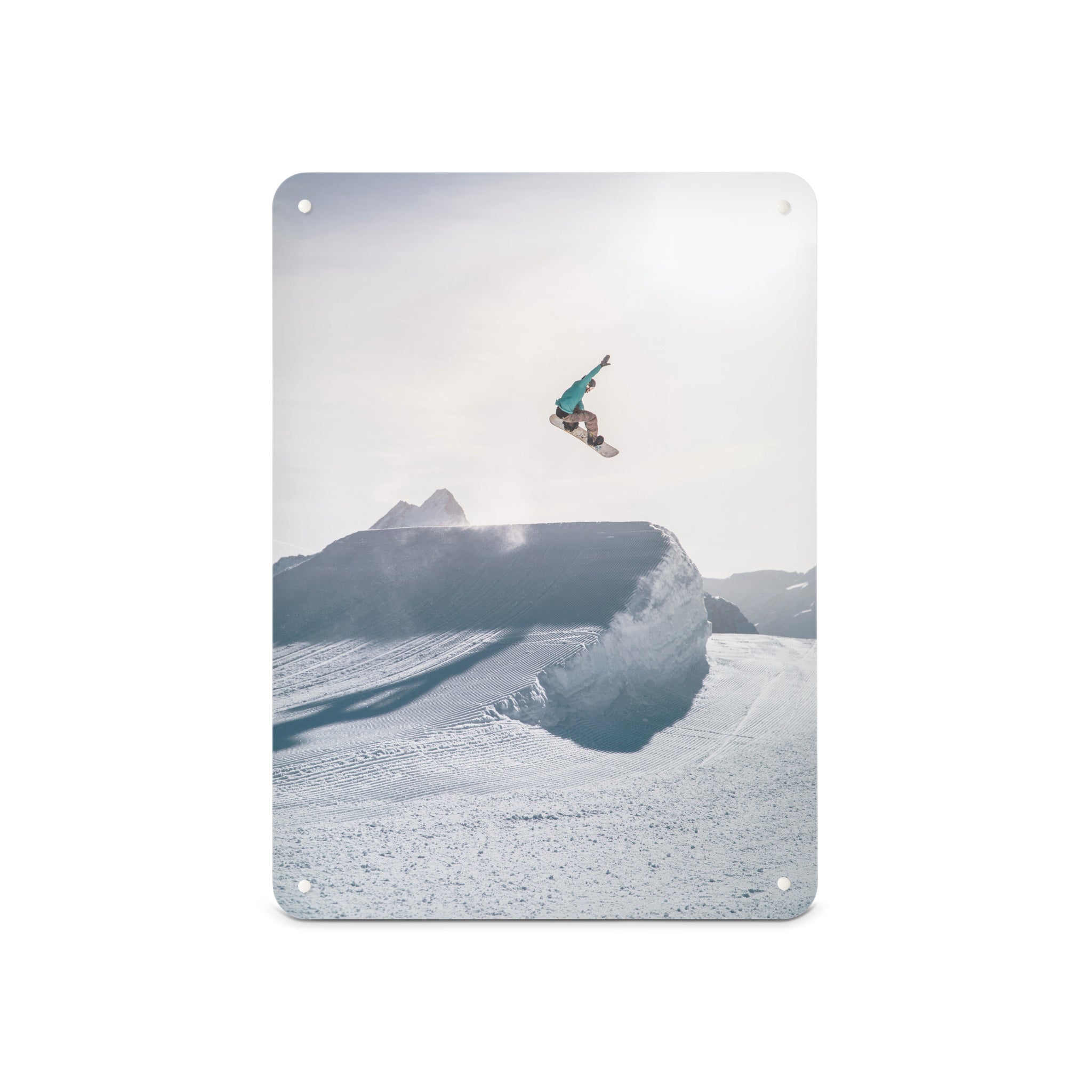 A medium magnetic notice board by Beyond the Fridge with a photograph of a snowboarder jumping on a snowboard in a bright snowy landscape