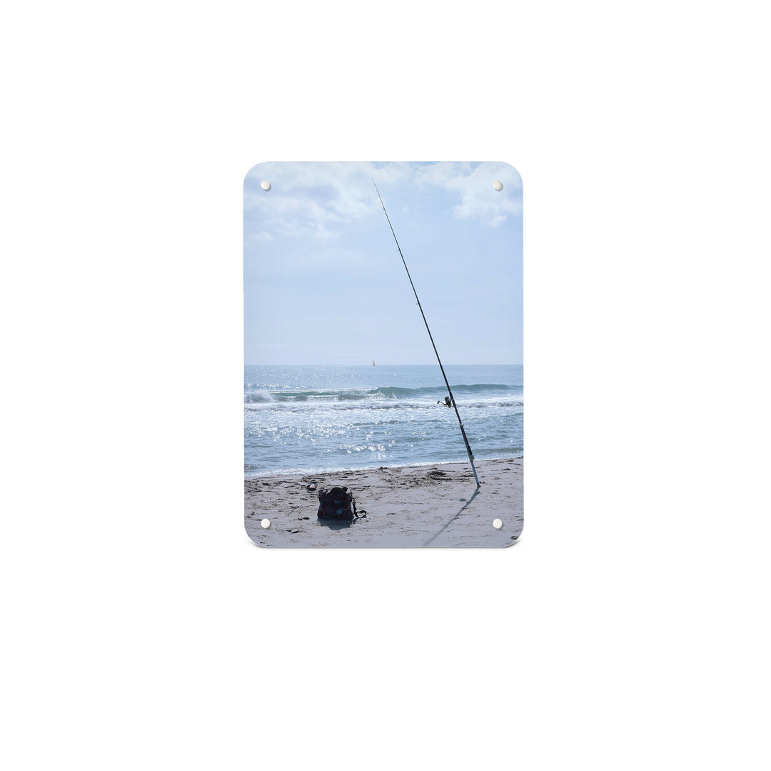 A small magnetic notice board by Beyond the Fridge with a photograph of fishing tackle on a sunny beach