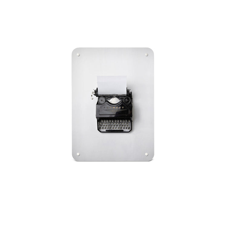 A small magnetic notice board by Beyond the Fridge with a photograph of a vintage typewriter on a white background