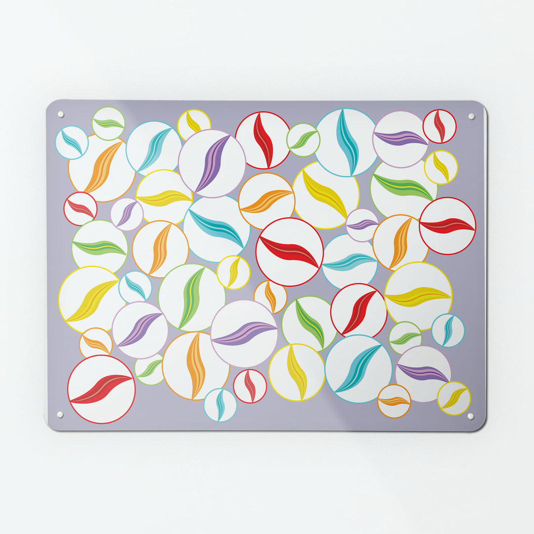 A large magnetic notice board by Beyond the Fridge with a design of multi coloured marbles on a mauve background