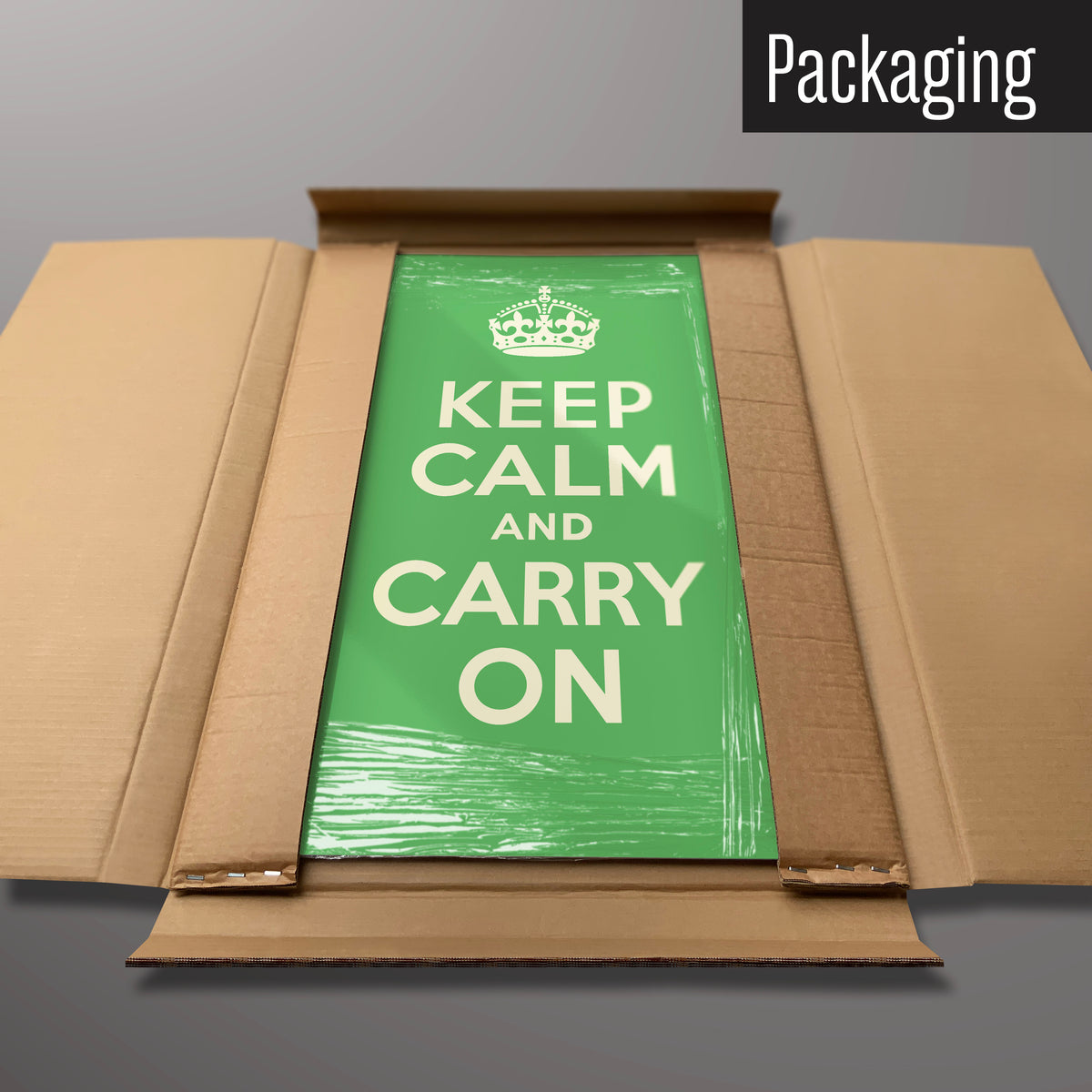 A green keep calm and carry on magnetic board in it’s cardboard packaging