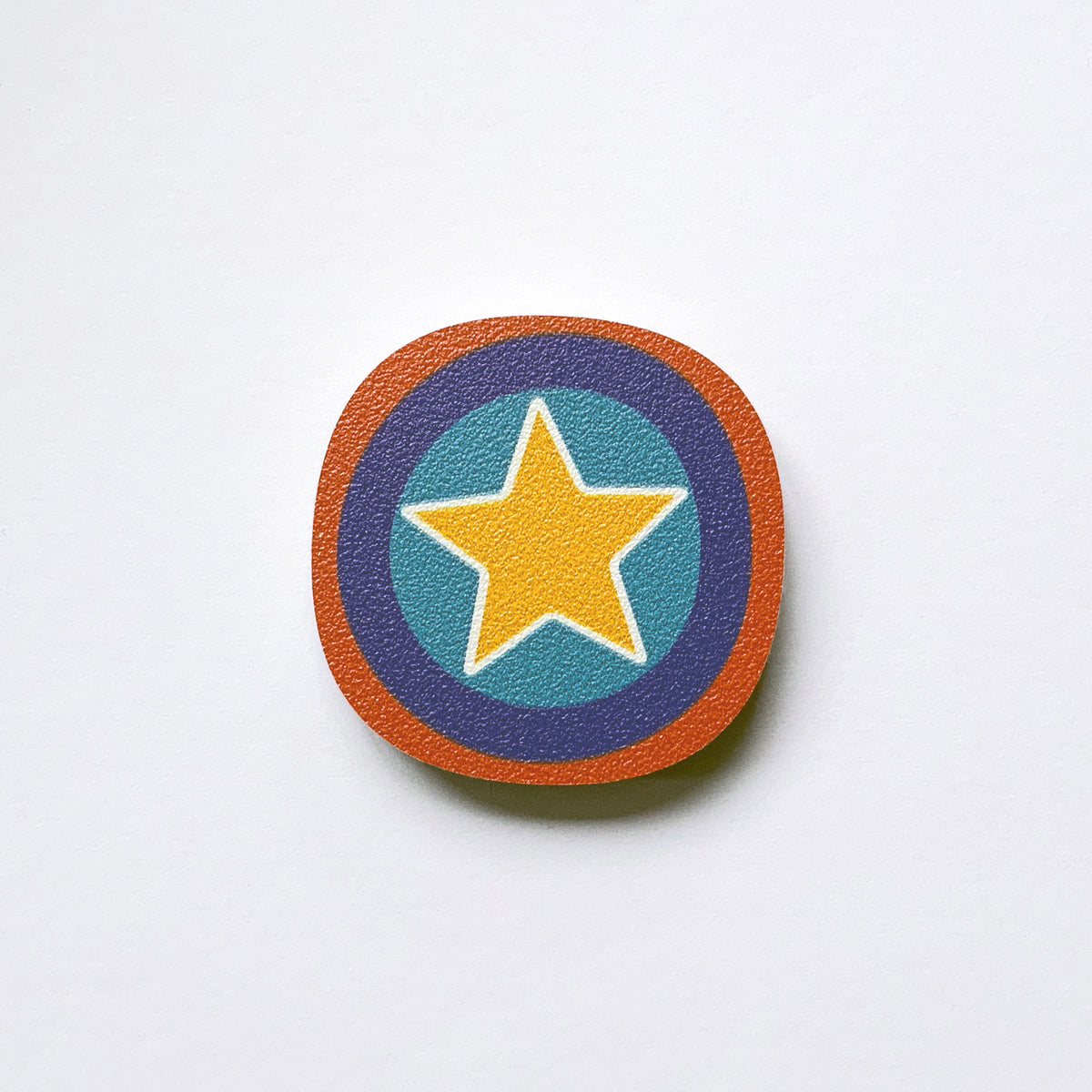 A yellow star millefiori design plywood fridge magnet by Beyond the Fridge