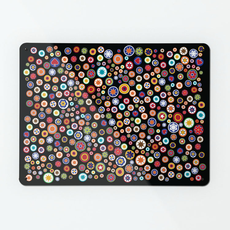 A large magnetic notice board by Beyond the Fridge with a scattered  millefiori  glass beads design on a black background