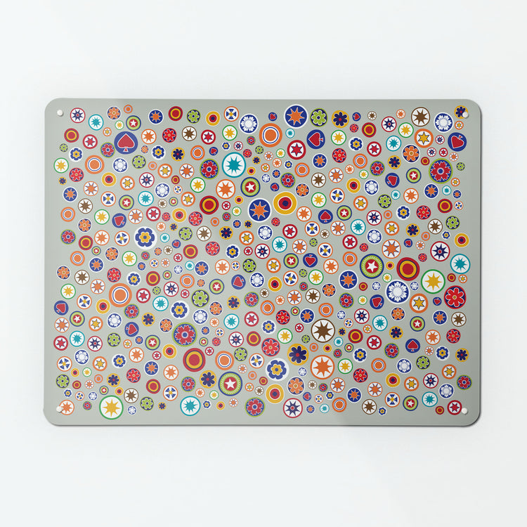 A large magnetic notice board by Beyond the Fridge with a scattered  millefiori  glass beads design on a grey background