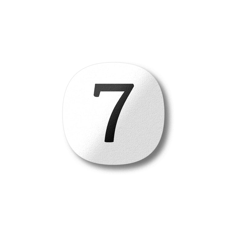 A black number seven on a white background design plywood fridge magnet by Beyond the Fridge