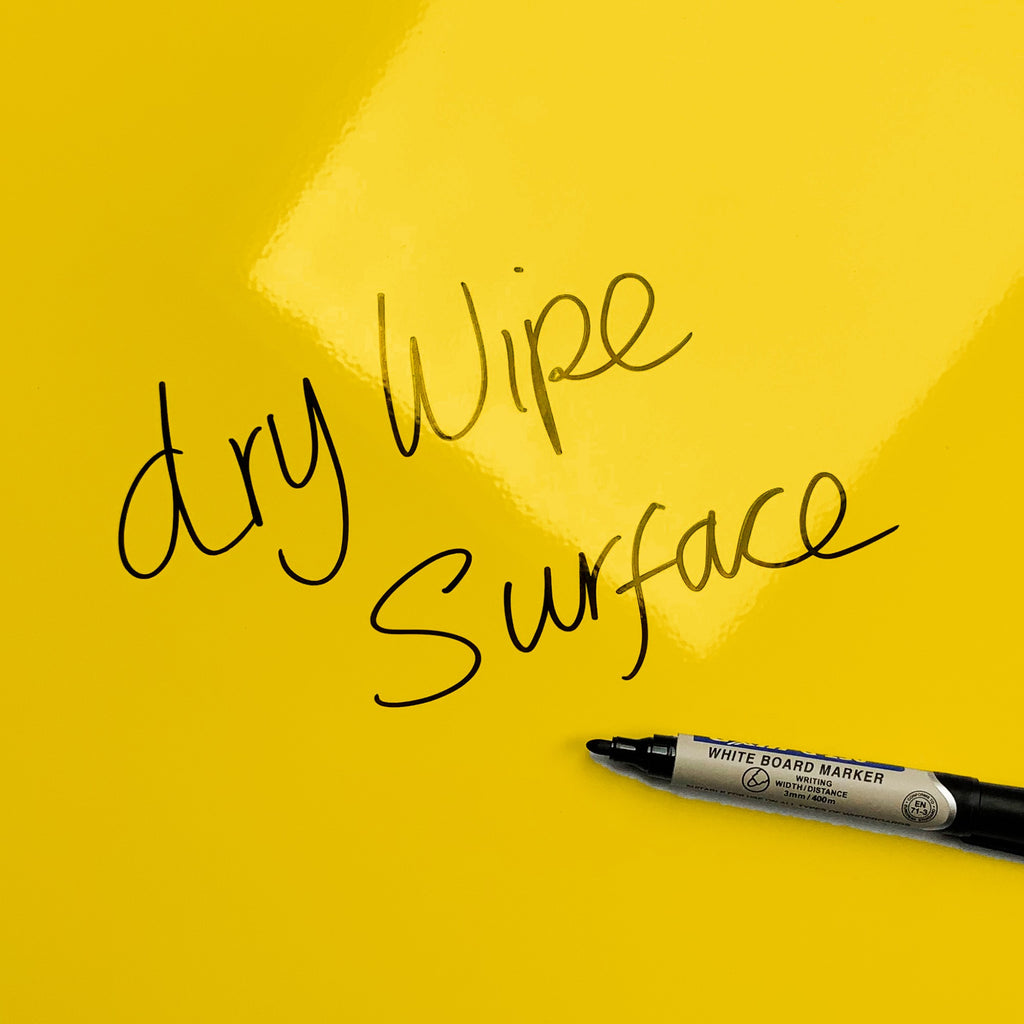 The words dry wipe surface written in marker pen on the Oranges and Lemons Oranges And Lemons magnetic notice board