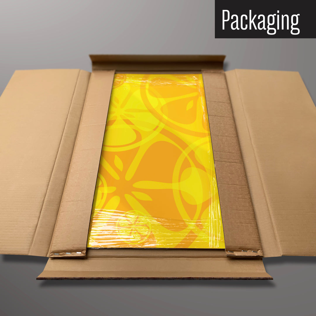 An oranges and lemons design magnetic board in it’s cardboard packaging